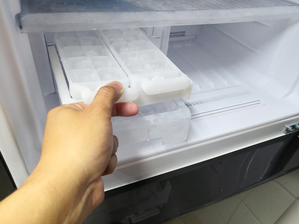 hand emptying ice cube tray
